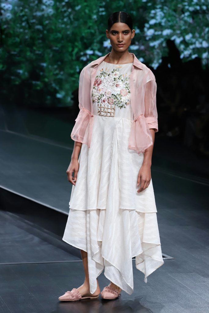 The image displays a woman wearing a sheer jacket, dress, and mules. Copyright Rajesh Kumar Verma/Pexels.