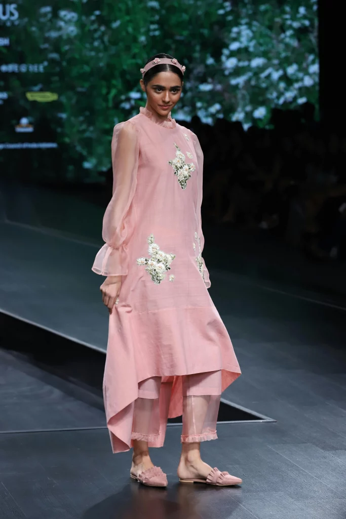 The image displays a woman wearing a kurta with a long dress and pants, as well as mules. Copyright Rajesh Kumar Verma/Pexels.