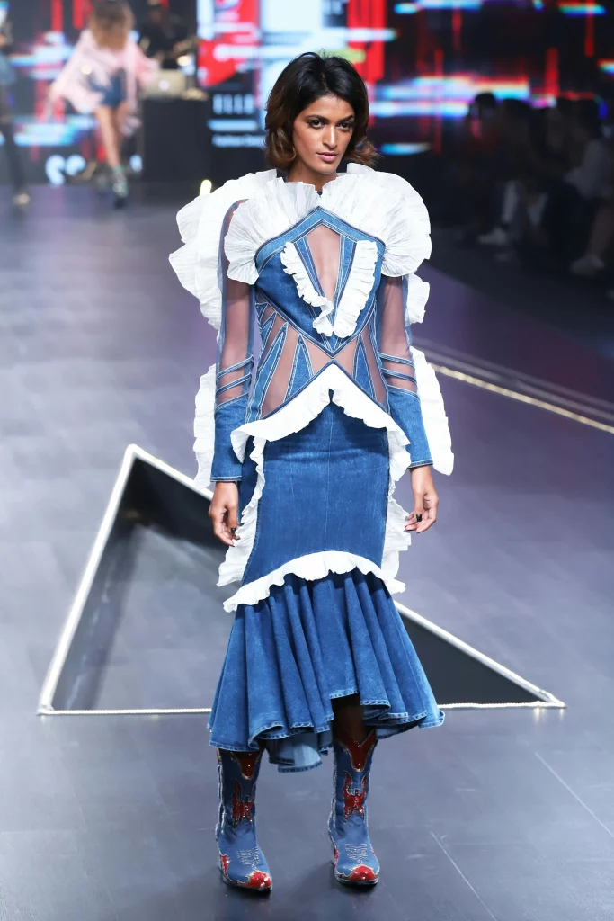 The image displays a woman wearing a denim dress and cowboy boots. Copyright Rajesh Kumar Verma/Pexels.