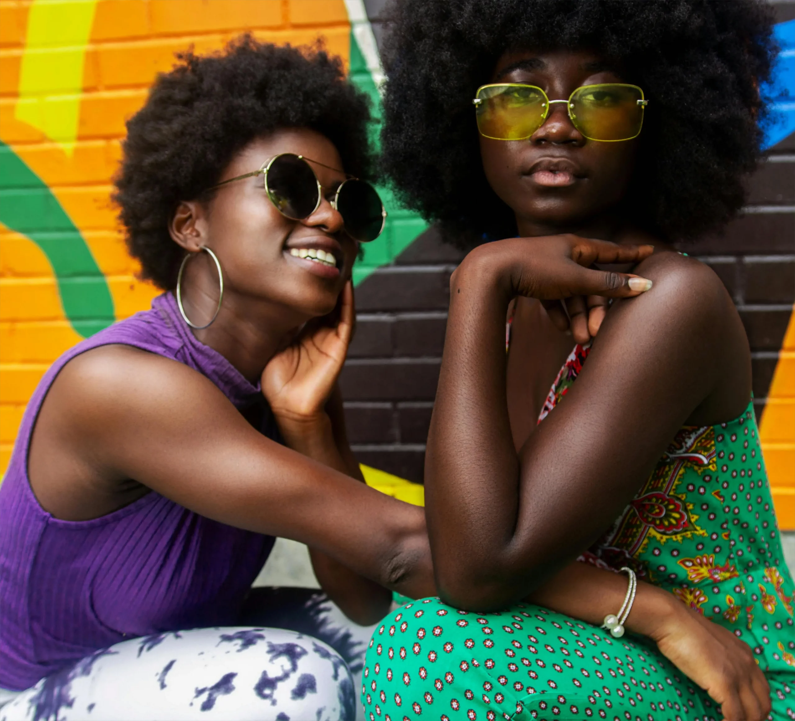 The image displays two stylish women who do not care about fashion rules. Copyright Tisha Vassel/Pexels.